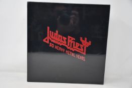 An as new Judas Priest 50 Heavy Metal Years collectors book.
