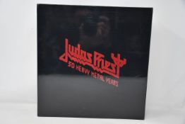 An as new Judas Priest 50 Heavy Metal Years collectors book.