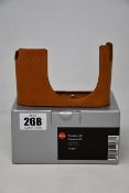 A boxed Leica brown leather protector-02 case.