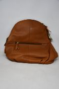 An as new Hannah Common natural tan leather back pack bag with dust cover.