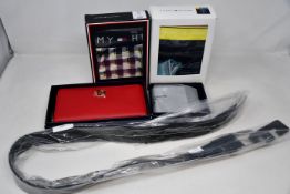 As new Tommy Hilfiger items; ladies Honey Purse, men's Eton Mini wallet, cotton trunk (M) and