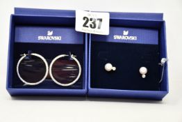 A pair of as new Swarovski pearl earrings (5559420) and a Swarovski stone hoop earrings (5389432).