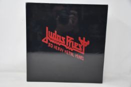 An as new Judas Priest 50 Heavy Metal Years collectors book.