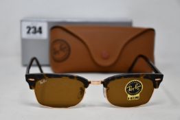 A pair of as new Ray Ban sunglasses.
