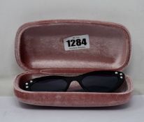 A pair of as new Miu Miu sunglasses.