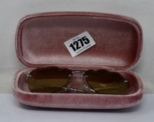 A pair of as new Miu Miu sunglasses.