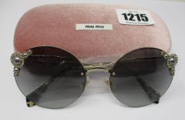 A pair of as new Miu Miu sunglasses.