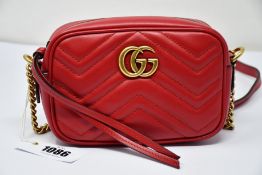 An as new Gucci Marmont bag in red with dust bag (RRP £840).