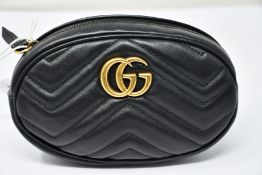 An as new Gucci Beltbag in black with dust bag (RRP £865).