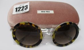 A pair of as new Miu Miu sunglasses.
