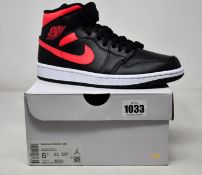 A pair of women's Air Jordan 1 Mid (UK 6).