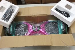 An as new unbranded balance board in rose red chrome and green chrome (Model No HY-A02).