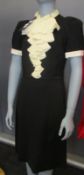 An as new Gucci black dress with cream ruffle (XS).
