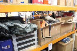 A shelf of miscellaneous items to include puzzles, glasses and Christmas trees.