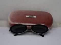 A pair of as new Miu Miu sunglasses.