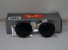 A pair of as new Ray Ban Round metal sunglasses.