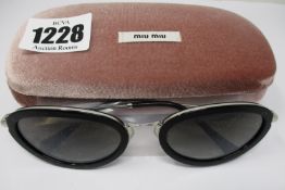 A pair of as new Miu Miu sunglasses.