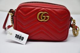 An as new Gucci Marmont bag in red with dust bag (RRP £840).