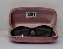 A pair of as new Miu Miu sunglasses.