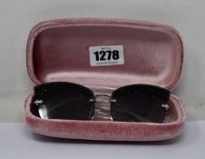 A pair of as new Miu Miu sunglasses.