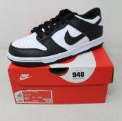 A pair of youths as new Nike Dunk Low (UK 4).