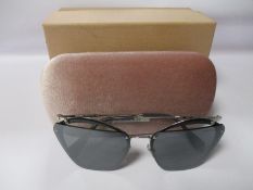 A pair of as new Miu Miu sunglasses.