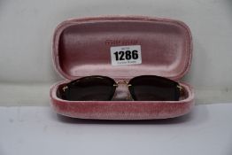 A pair of as new Miu Miu sunglasses.