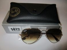 A pair of as new Ray Ban Aviator large metal sunglasses.