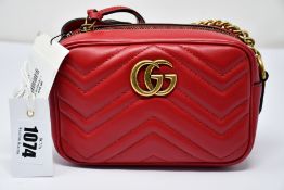 An as new Gucci Marmont bag in red with dust bag (RRP £840).