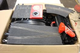 A quantity of pre-owned Scalextrix road pieces and two controllers.