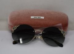 A pair of as new Miu Miu sunglasses.