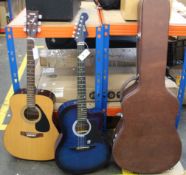 A pre-owned Lindo LDG-933CTBLS acoustic guitar and a Yamaha F-310 acoustic guitar with a hard case.