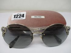 A pair of as new Miu Miu sunglasses.