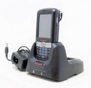 A pre-owned Honeywell Dolphin 60s Mobile Computer Barcode Scanner with cradle and power supply.