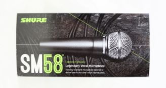 A boxed as new Shure SM58 SE Vocal Microphone (Box opened, some damage to packaging).