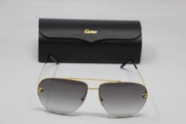 A pair of as new Cartier sunglasses.