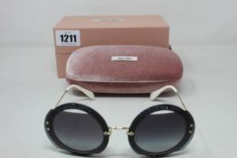 A pair of as new Miu Miu sunglasses.