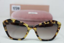 A pair of as new Miu Miu sunglasses.