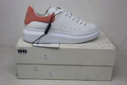 A pair of as new Alexander McQueen low top sneakers in white/rose quartz (EU 38).