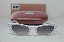 A pair of as new Miu Miu sunglasses.