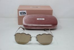 A pair of as new Miu Miu sunglasses.