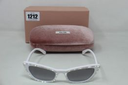 A pair of as new Miu Miu sunglasses.