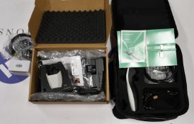 An Interacoustics Titan Tympanometer with accessories including charging cradle.