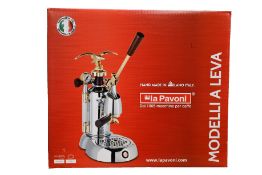 A boxed as new La Pavoni Europiccola chrome lever espresso/cappuccino machine.