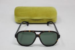 A pair of as new Gucci sunglasses.