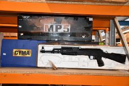 Three airsoft guns to include a Cyma, MP5 069 and an unbranded airsoft gun.