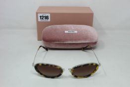 A pair of as new Miu Miu sunglasses.