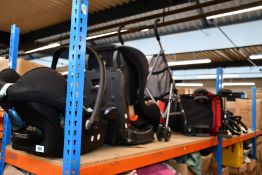 Three pushchairs/buggies and two car seats/booster seats.