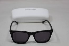 A pair of as new Calvin Klein sunglasses.