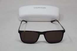 A pair of as new Calvin Klein sunglasses.